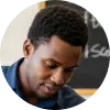 A circular profile picture of Bongani Ndlovu, a skills development trainer, smiling in a modern office.