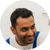 A circular profile picture of Patrick Govender, a plumbing business owner, smiling.